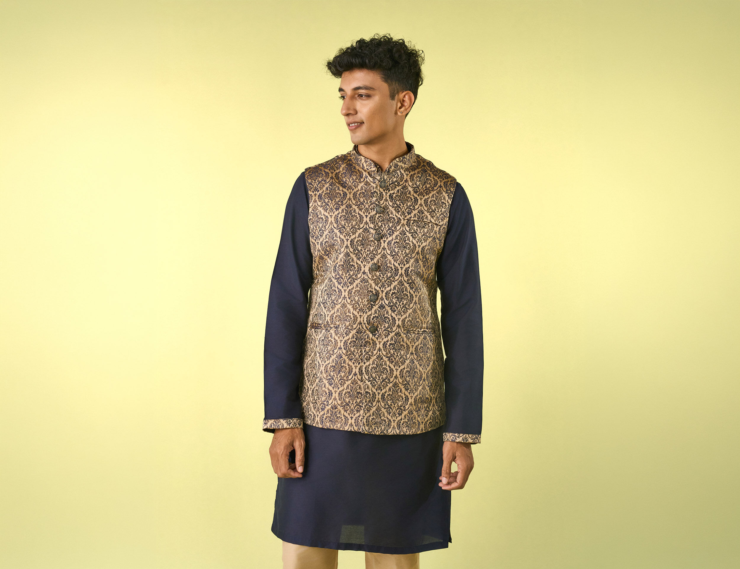 Man wearing a black kurta pajama paired with a matching Nehru jacket, showcasing a sophisticated and timeless ethnic look suitable for festive celebrations, weddings, and formal occasions.